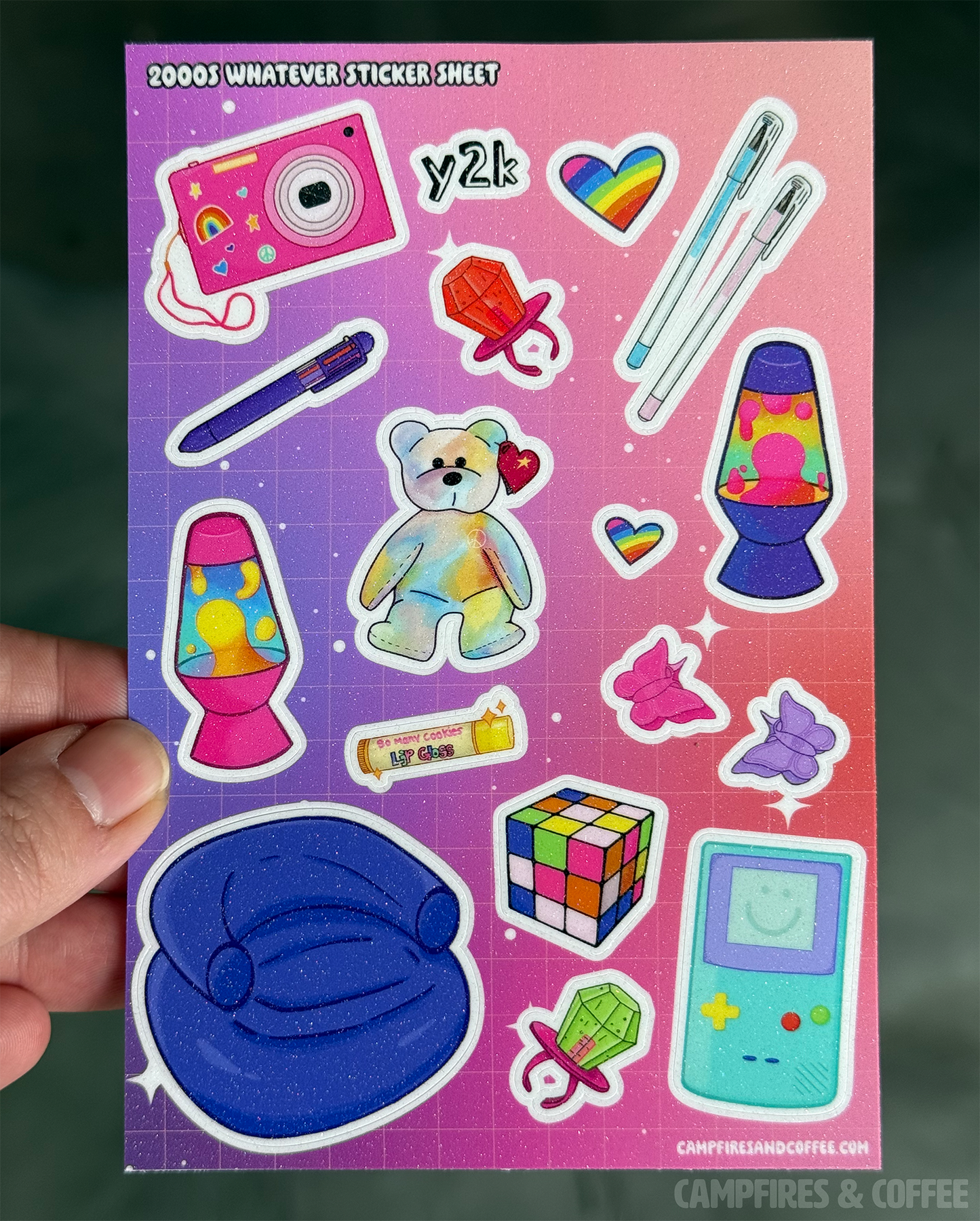Sticker sheet with colorful retro-themed stickers held by a hand against a dark background