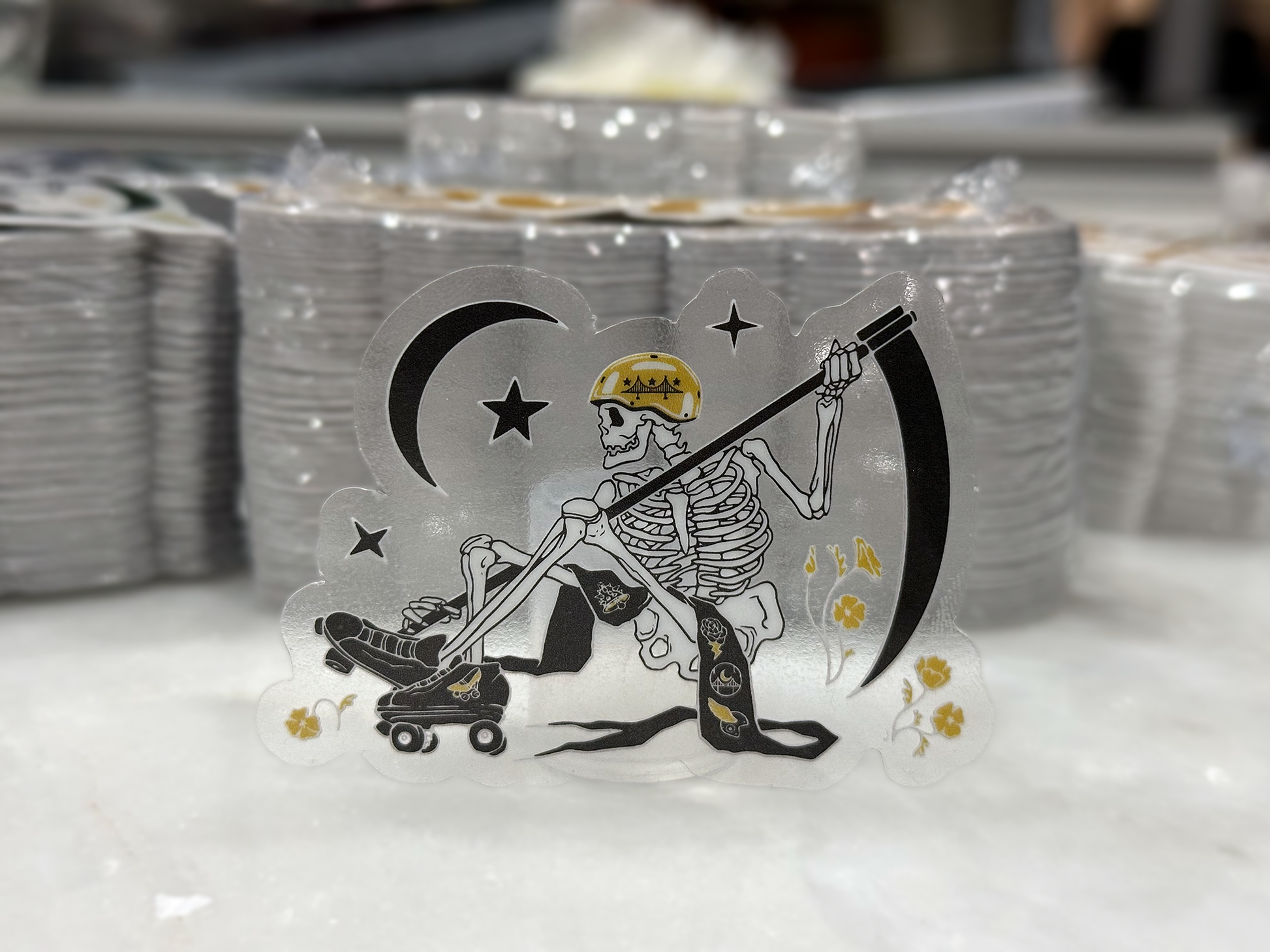 Clear sticker featuring an opaque white skeleton in front of stacks of stickers